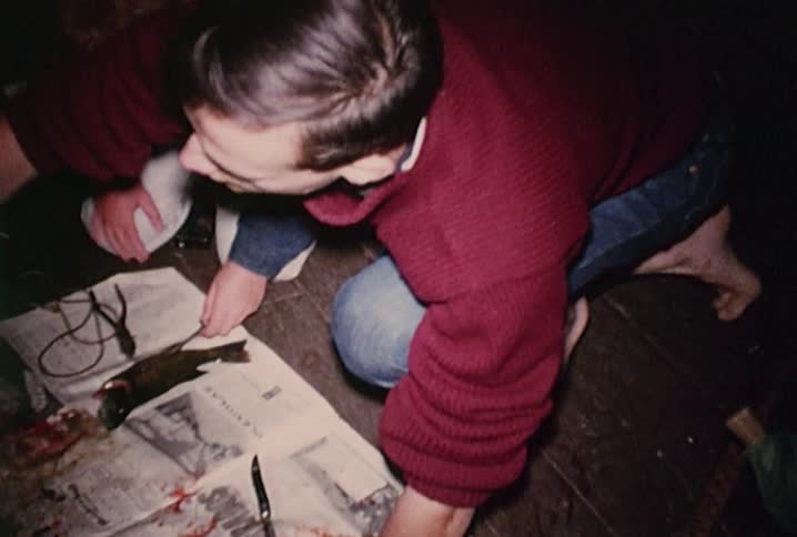Old footage of people cleaning fish