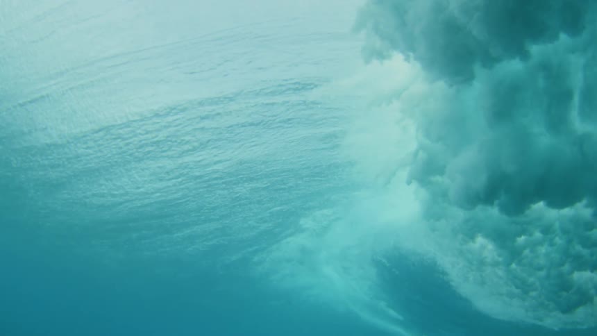 Underwater view of a wave crashing down in the ocean