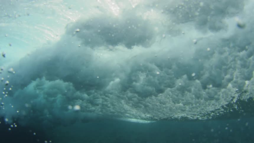 Underwater view of waves rolling in ocean