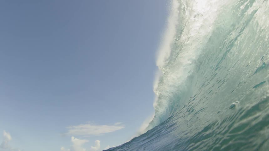 A large wave crashing onto a camera and pushing it underwater
