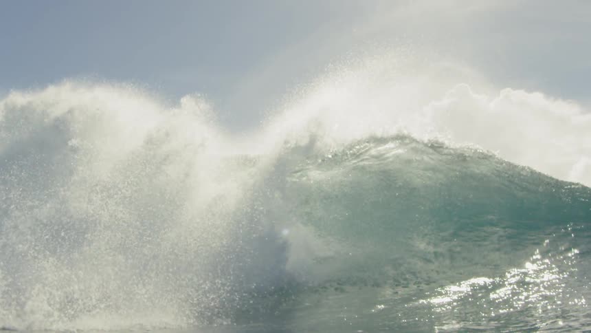 cinematic slow motion wave crashing into camera lens