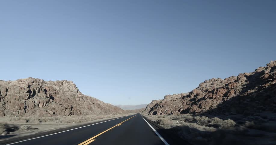 A road in the desert with the sky in the background