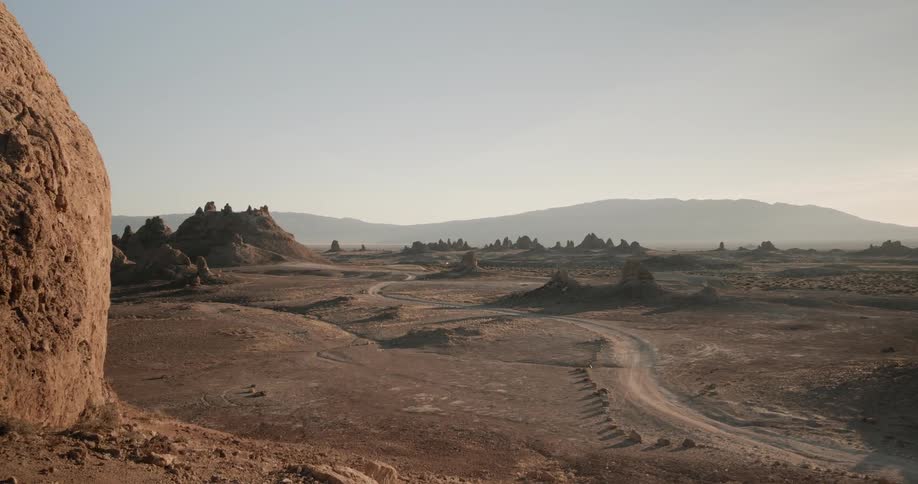 Mountains and sand sit under a blue sky