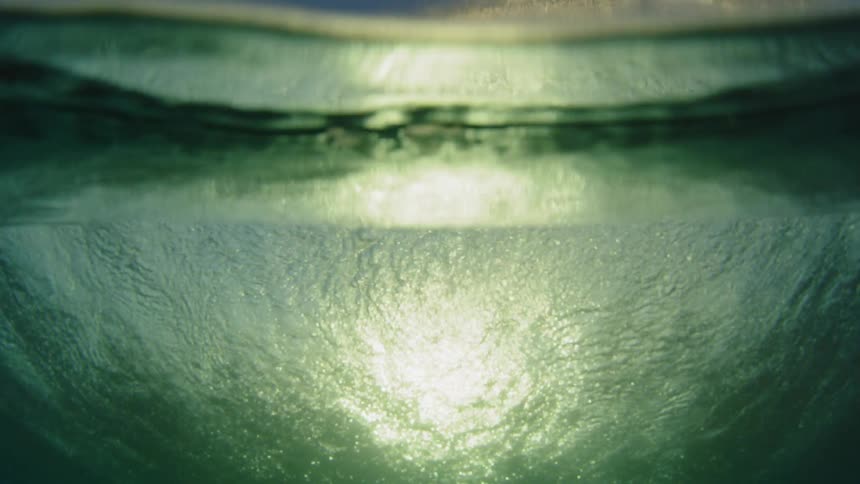 cinematic reveal of a wave rolling over camera lens