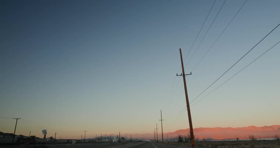 Driving on a road at sunset in a rural area