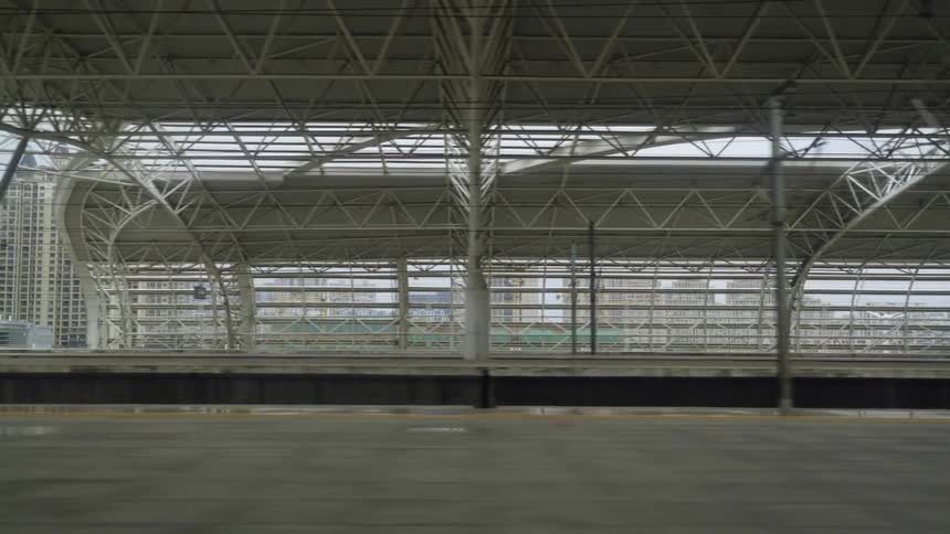 A train station with buildings in the background