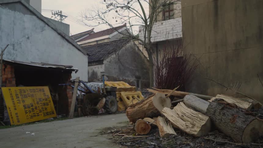 Piles of wood and garbage sit in a street