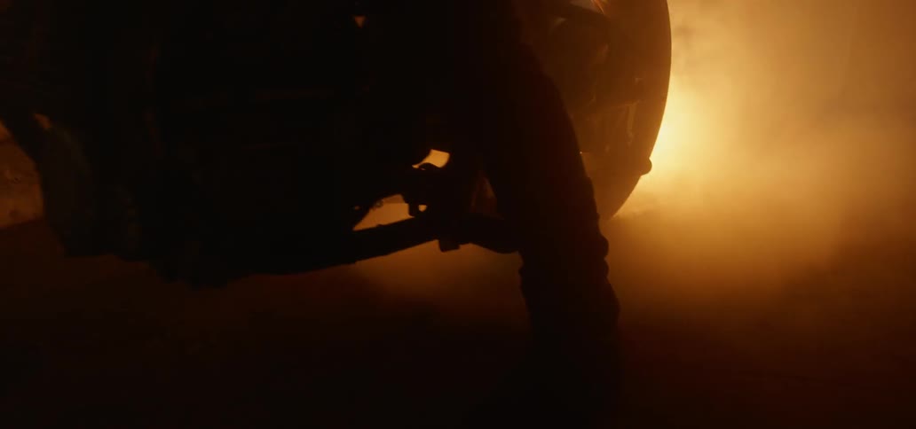 Fiery light emitting from the exhaust of a motorcycle in a dark room