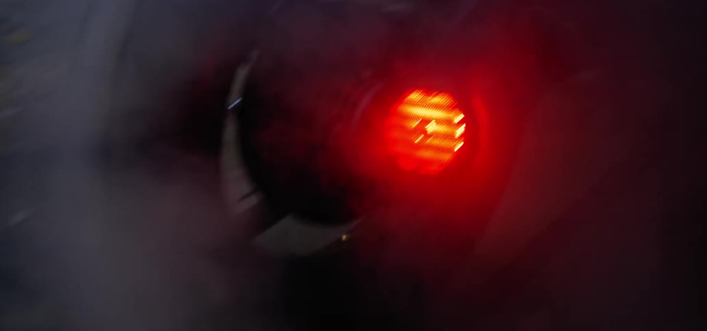 A man sits on his motorcycle at night