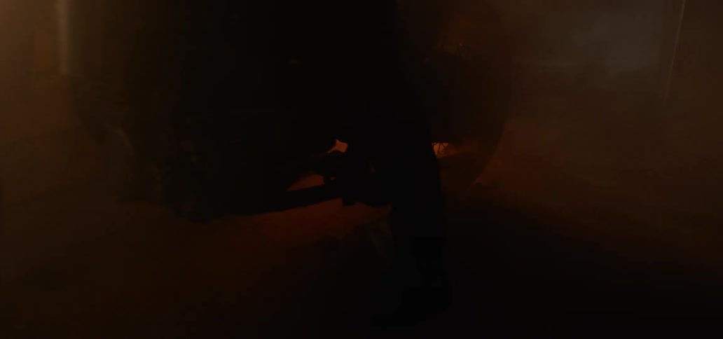 A rider sits on a motorcycle while flames and smoke come out of the exhaust