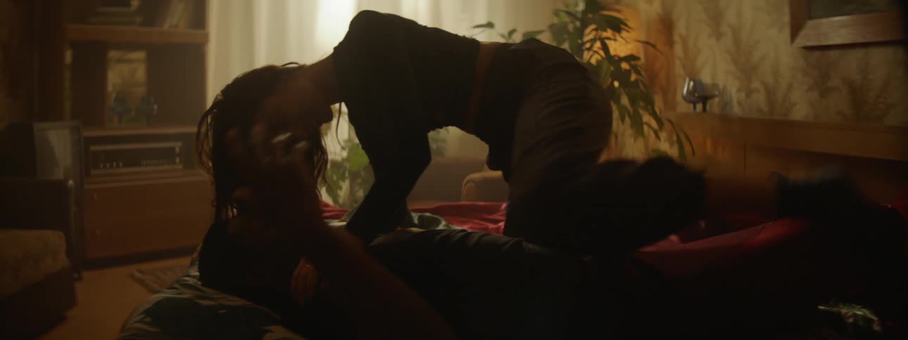 A man and a woman rolling in bed