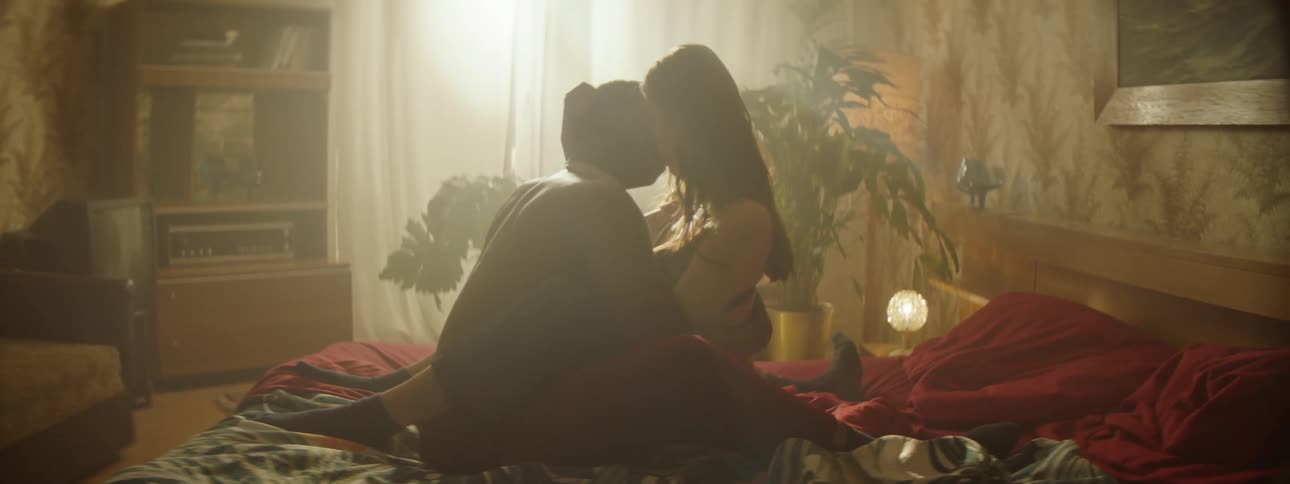Couple kissing at the bed