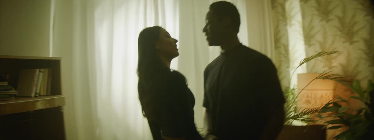 A girls runs in to a room with a boy following her and holding her hand