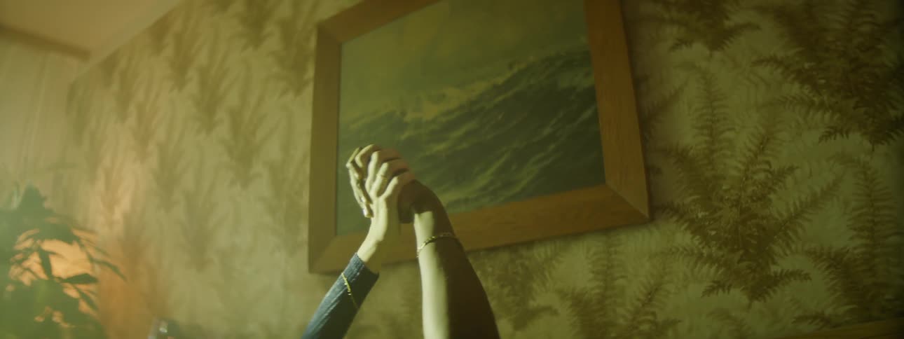 Male and female raise one arm up in the air open their fingers wide and hold each others hand in the air