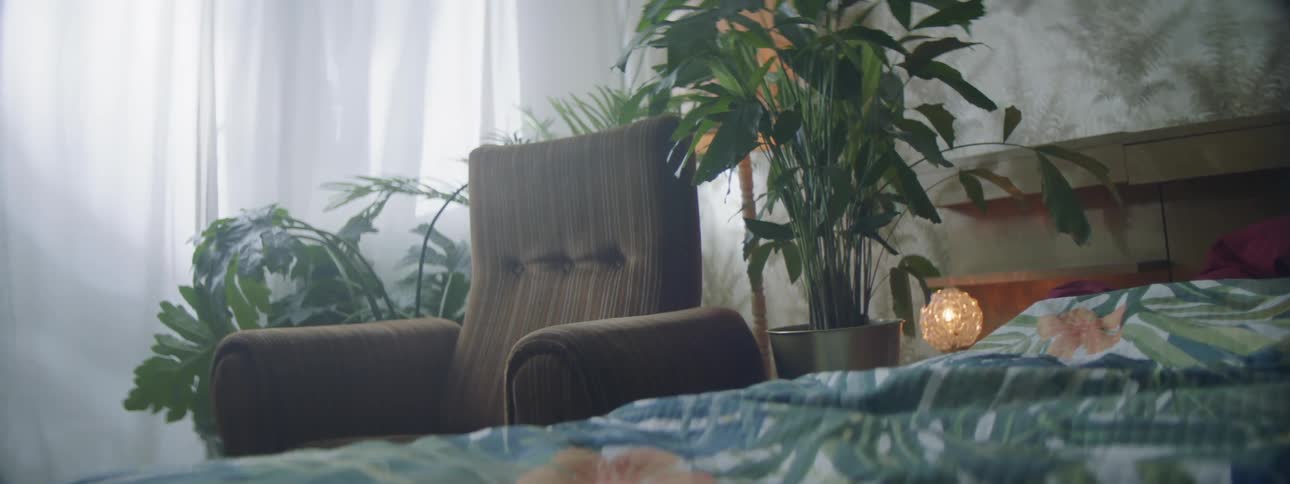 A recliner next to a bed in a bedroom