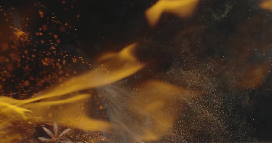 Flames and smoke across as debris flies about