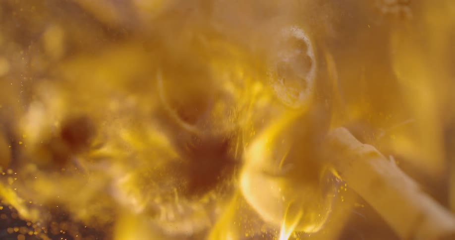 A pile of potpourri is launched in the air as a flame ignites and burns it