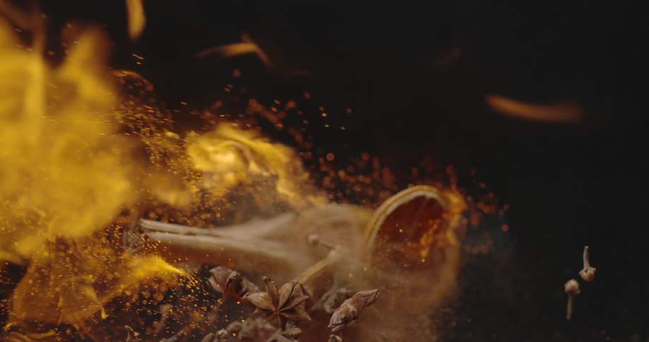 A burst of flames engulfing and passing over sticks of cinnamon