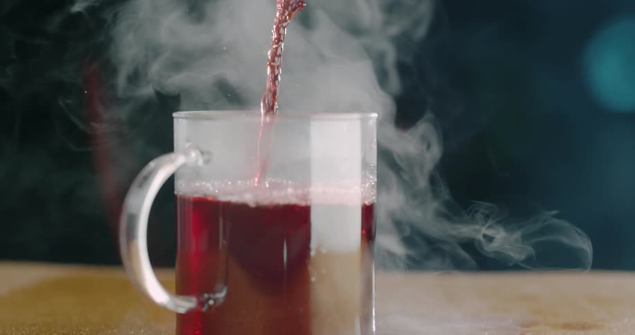 Beverage poured into mug releasing vapor into air
