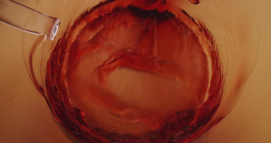 Red wine being poured in to a glass