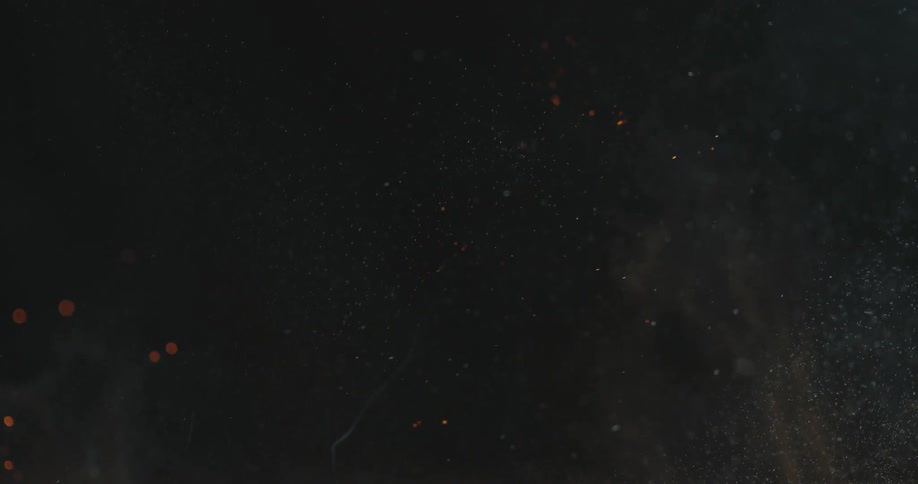 Flamesdisipate in dark air leaving sparks and smoke