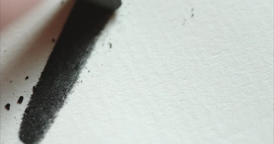 A hand putting chalk to paper