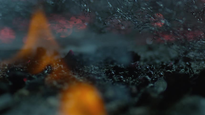 A fire burning with smoke and ash