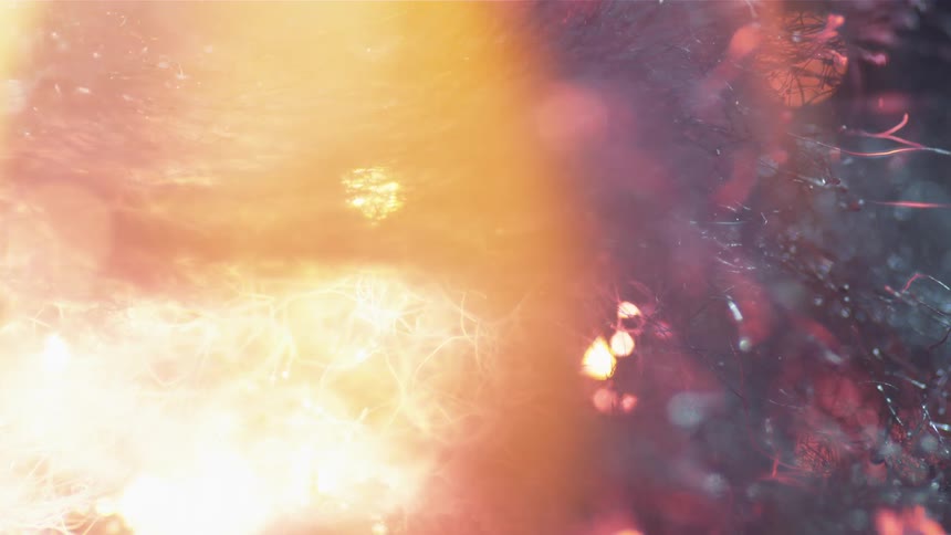 Sparks and smoke rise from burning fibers