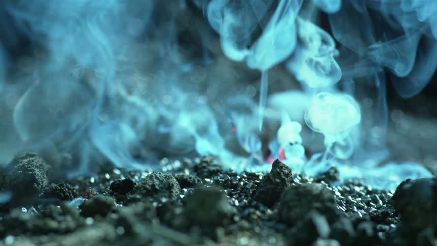 Smoke floats up from the burning embers