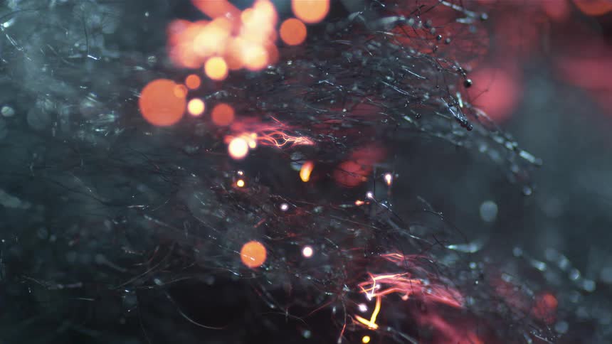 Fire blackens fibers releasing sparks and smoke
