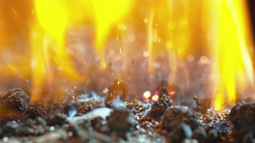 Bright flames burning over hot coals