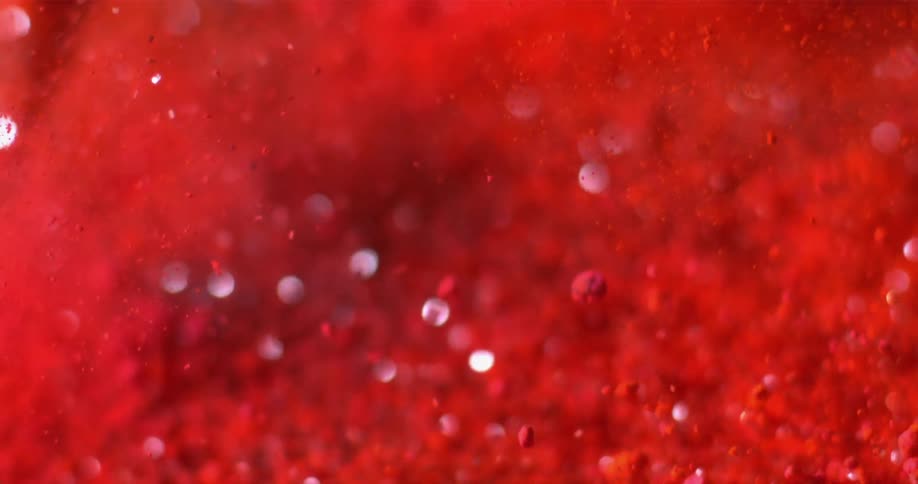 Grains of red powder fly in all directions
