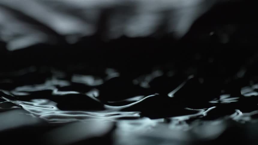 Abstract footage of droplets falling in to liquid