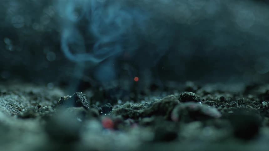 A flame with smoke and ashes