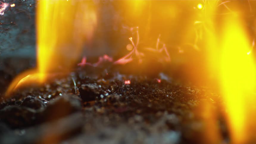 Hot embers glow as a fire burns