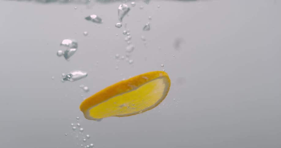 Slices of lemon fall in to water