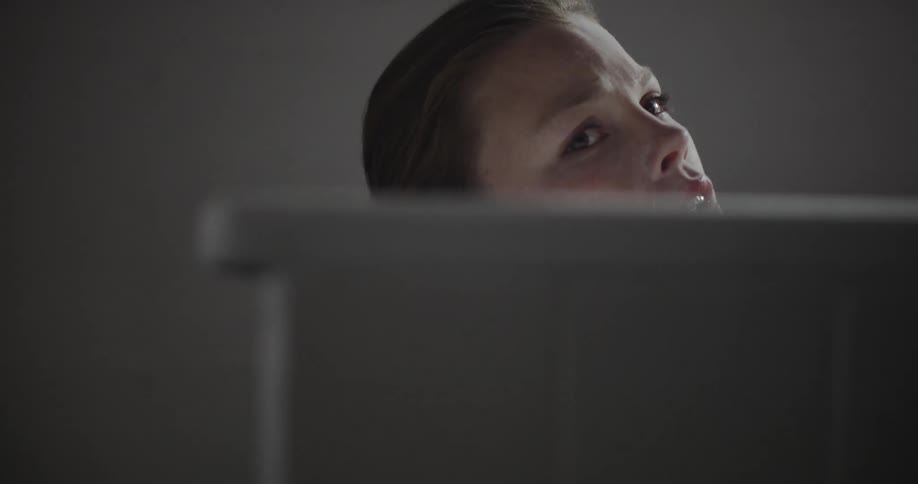A woman sits in the bathtub