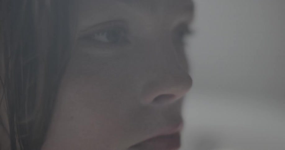 Close up of woman face who turns to look at the camera