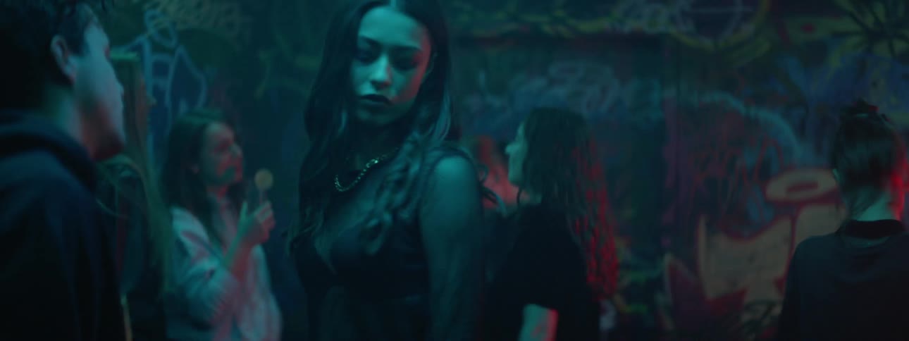 Couple dancing in nightclub filled with graffiti