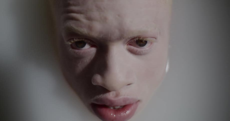 A males head emerges from water