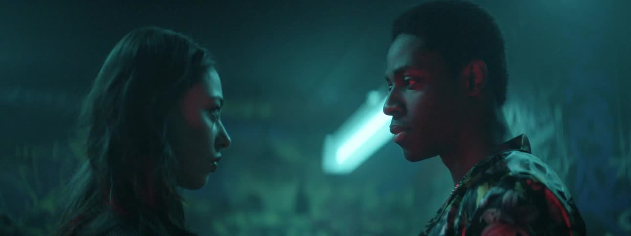 A young man and woman stare longingly into one another