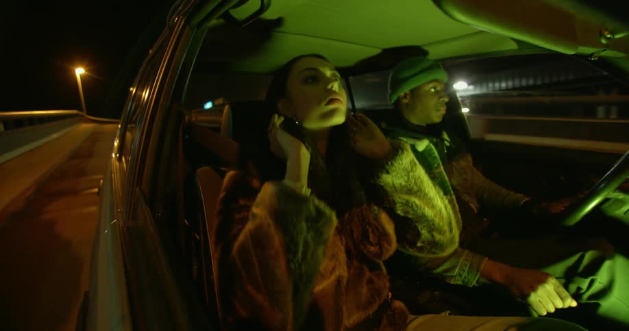 A man and woman are in the car