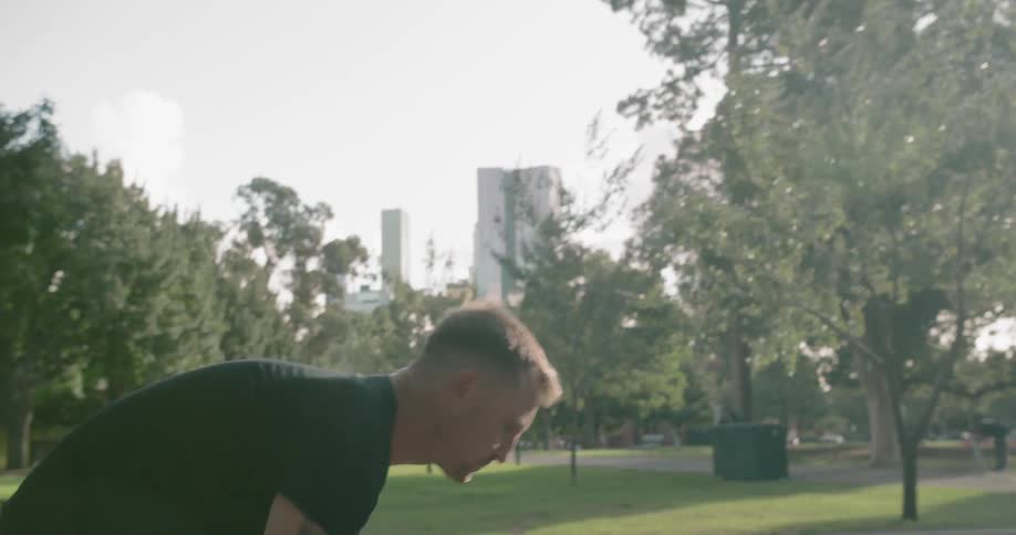 Man dribbling ball on basketball court in public park