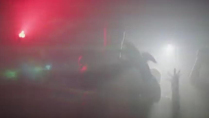 People dancing in a room with flashing strobe lights