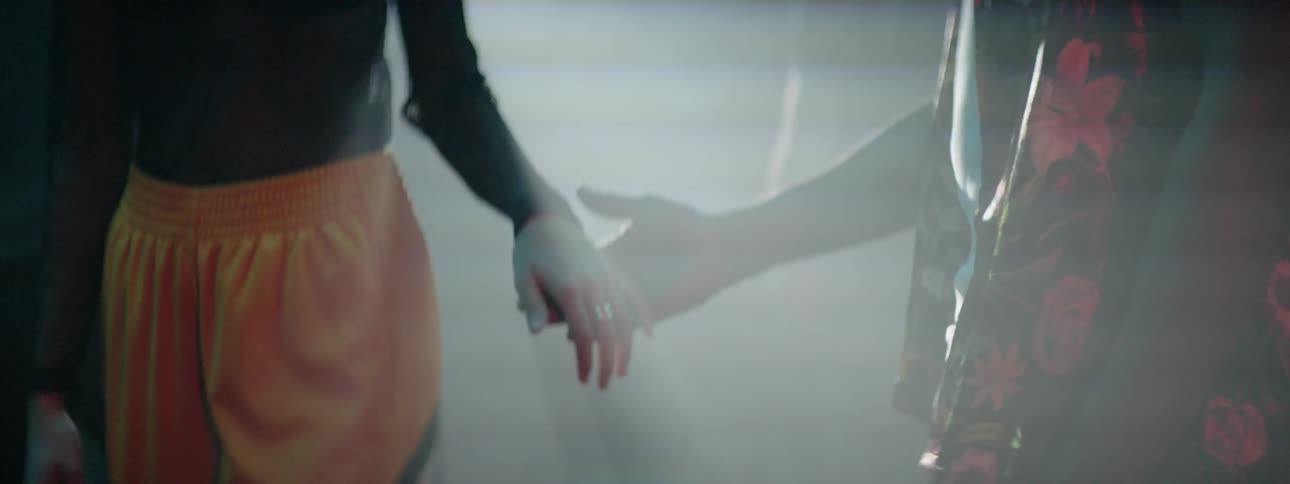 Couple enters a party on nightclub holding hands