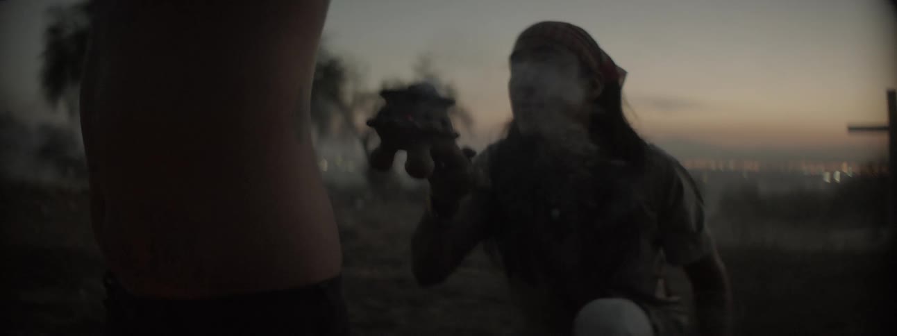 A man holds smoke near a person