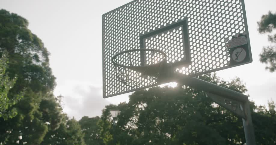 A basketball hitting the backboard of a basketball hoop and bouncing off