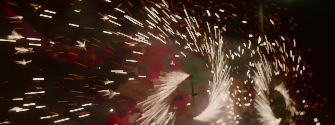 Sparks shooting out of spinning discs at night