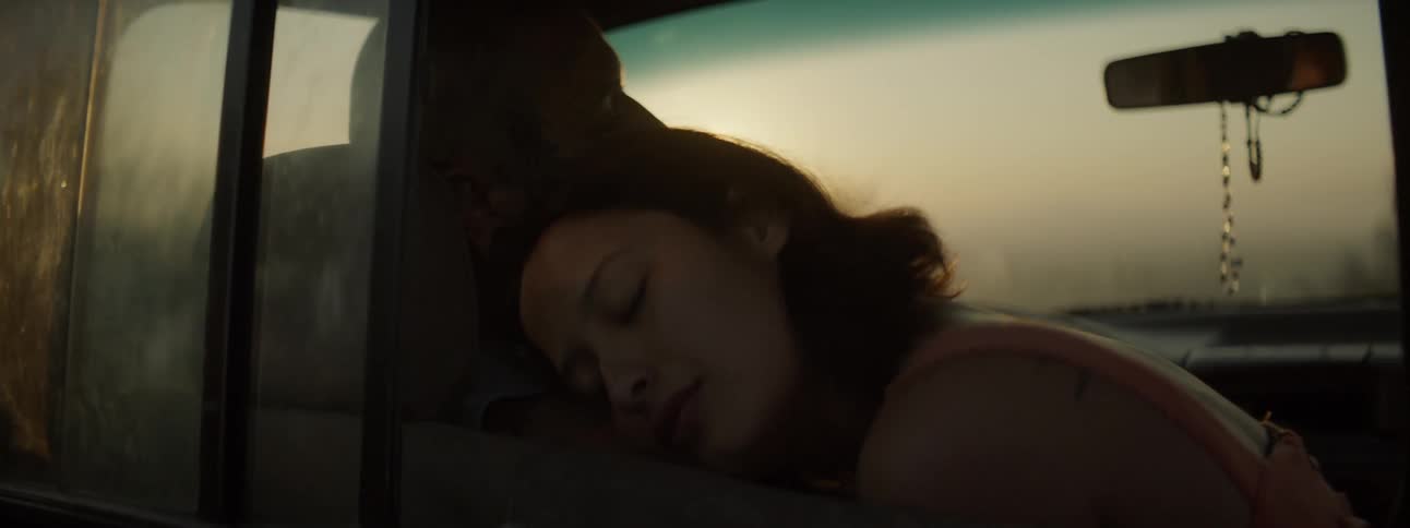 A young couple frolicking in a car