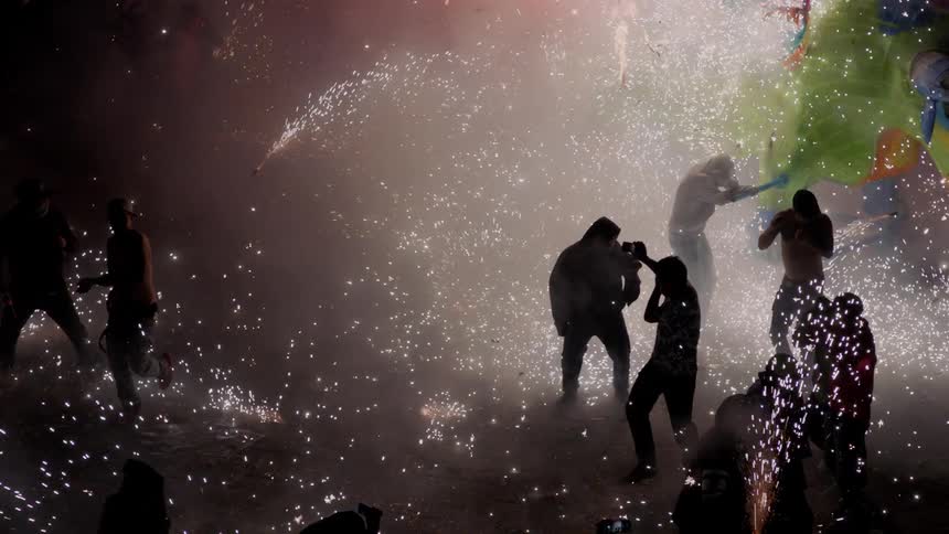 A firework festival with people shooting fireworks at each other